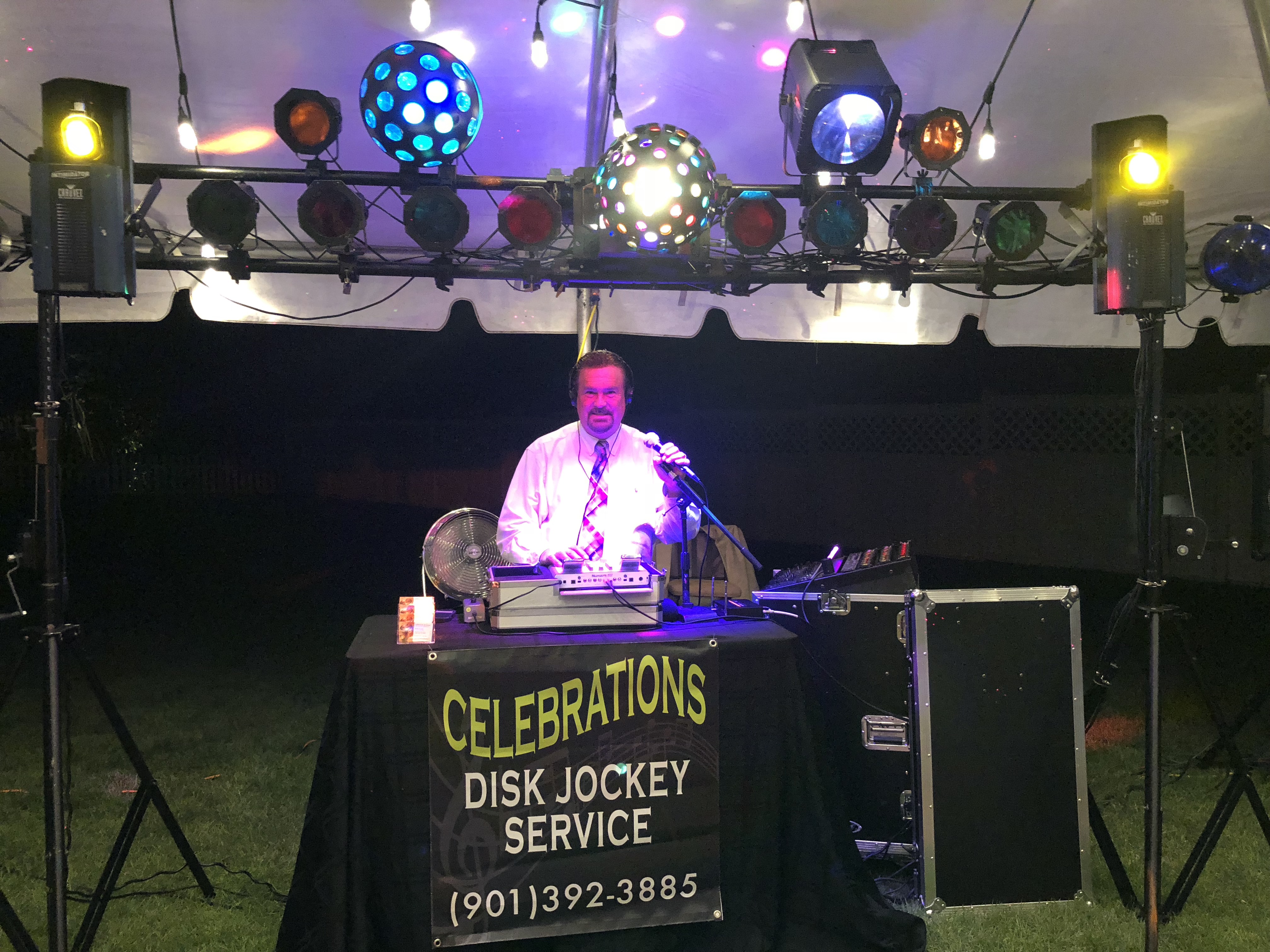 DJ smiling while playing music in a party