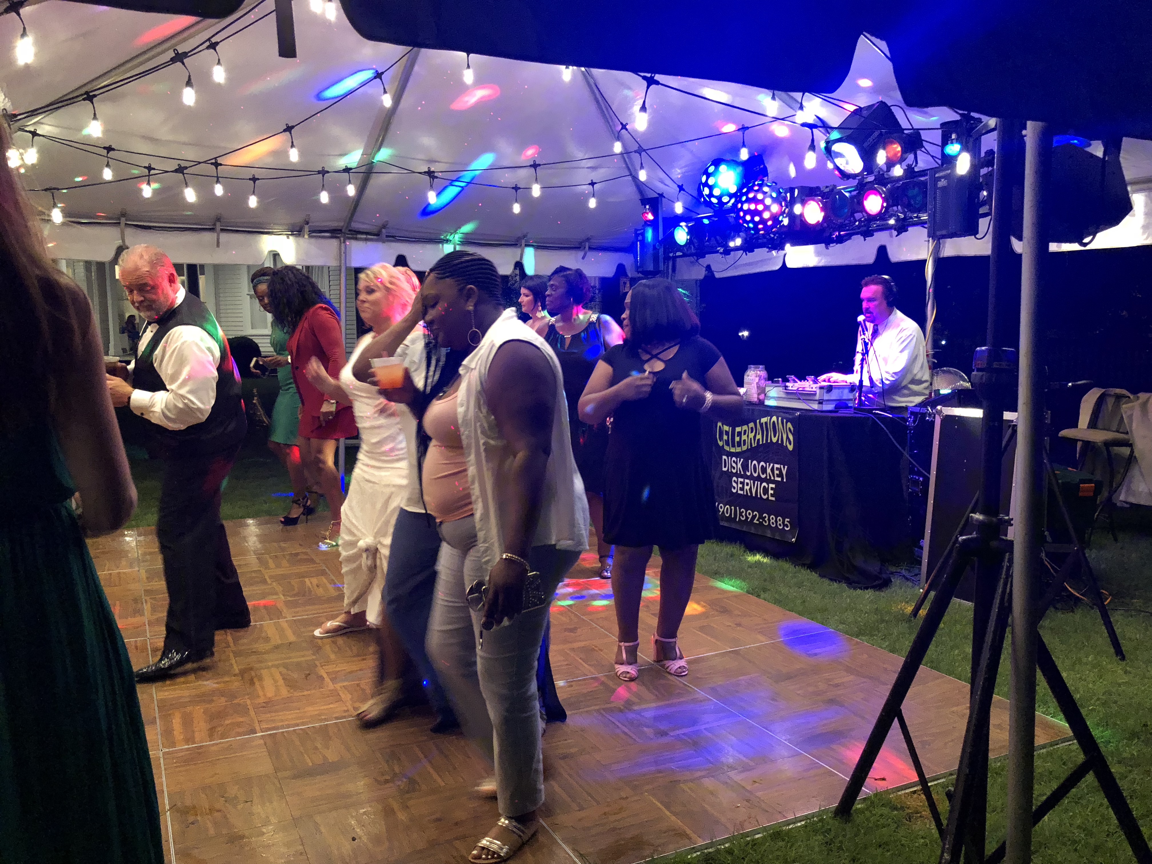 Group of people dancing under the tent