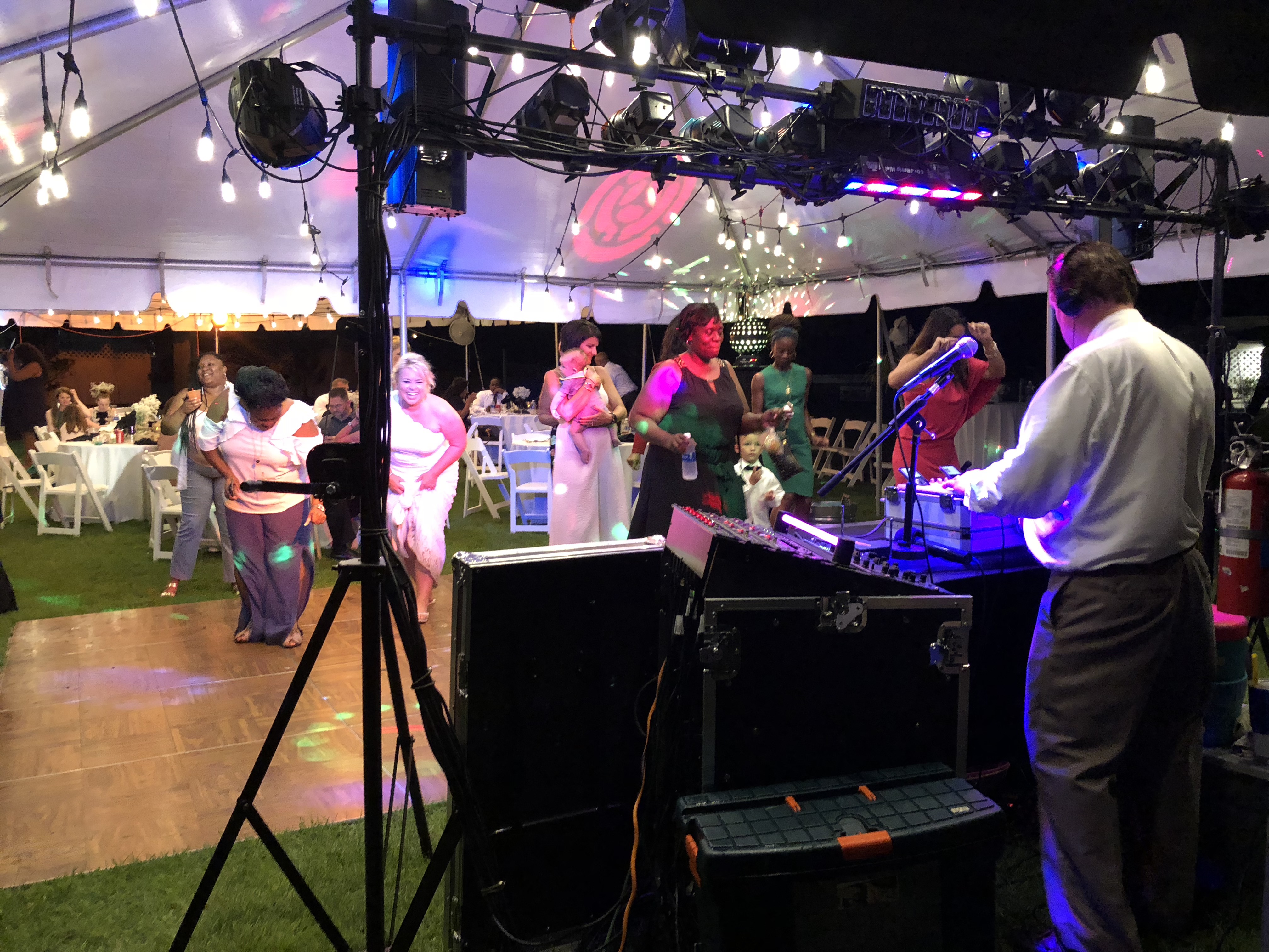 Group of women dancing in front of DJ and lights